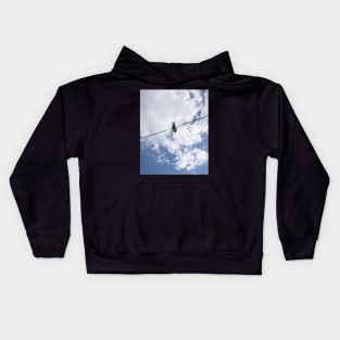 Girl in slingshot against blue cloudy sky Kids Hoodie